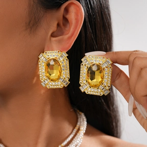 Elegant gold square earrings with yellow gemstones and rhinestones shown on model