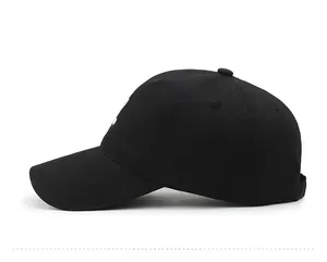 Side view of a classic black cotton canvas baseball cap with a curved brim