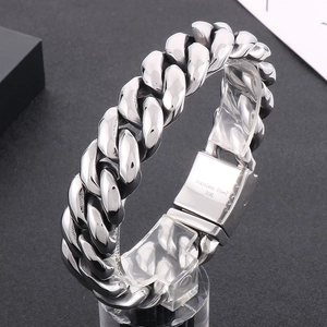 Macro shot of 316L stainless steel Cuban link bracelet with engraved clasp details