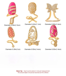 Detail view of 6-piece gold alloy nail ring set with pink enamel and crystals