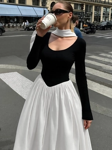 Elegant long sleeve dress with black bodice and contrasting white high-waist flared skirt