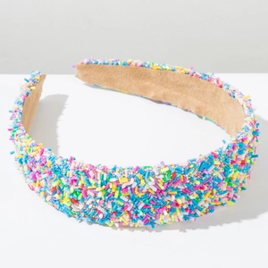 Detail of colorful sprinkles texture and khaki suede lining on wide fashion headband