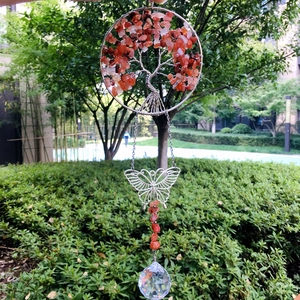 Macro detail of Tree of Life suncatcher with orange crystals and hanging crystal prism
