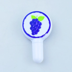 Close-up of novelty lollipop toy pen top featuring a cute purple grape pattern print