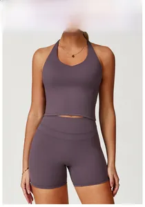 Detail of cross back yoga set in eggplant purple showing high waist shorts and racerback top