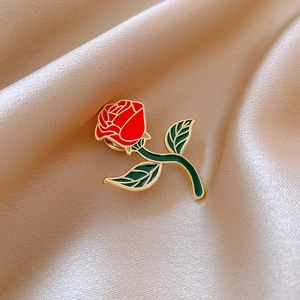 Detailed close-up of 14k gold-plated pearl flower brooch on elegant silk background
