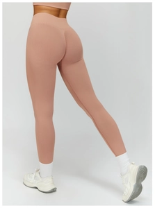 Detailed view of high waist ribbed waistband and peach pink seamless yoga pants
