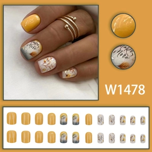 Autumn themed yellow and white press-on nails with leaf patterns and flower designs