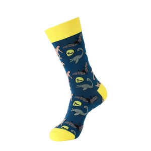 Vue détaillée de chaussettes bleu foncé avec motifs d'aliens verts et de dinosaures