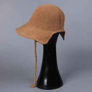 Detail of camel knit bucket hat texture and matching long braided tie strap