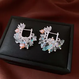Silver drop earrings with pink pearl, blue stones and zircon on black jewelry box