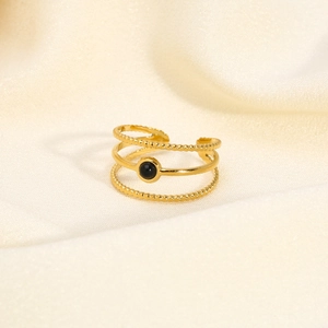 Detailed macro shot of 18K gold plated multi-layer ripple ring with a black gemstone