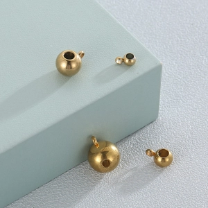 Macro shot of 18K gold plated stainless steel spacer beads with small hanging loops