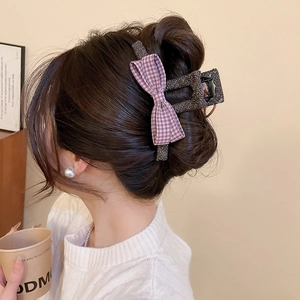 Detail of Korean style tweed hair claw clip with purple plaid bow on model's hair