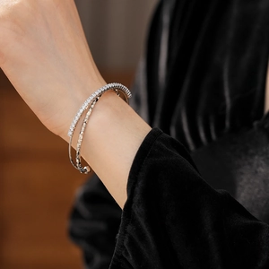 Close-up of double-layered silver bangle with cubic zirconia pave and geometric bars