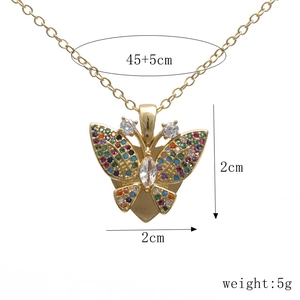 Detail view of gold butterfly pendant with colorful zircons and size measurements