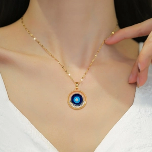 Elegant gold evil eye necklace with blue center and zircon stones on a female model