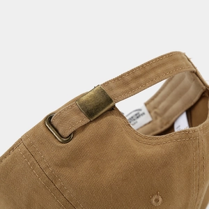 Macro shot of khaki cotton baseball cap back with bronze metal adjustable buckle