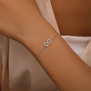 Detail of a 925 silver infinity bracelet with pavé cubic zirconia on woman's wrist