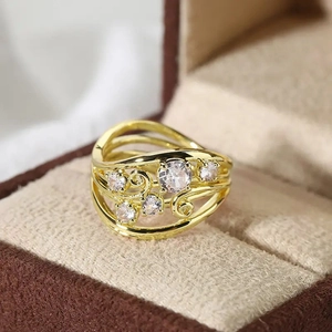 Macro shot of vintage gold layered openwork ring with vine motifs and white zircon stones