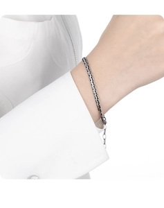 Detailed view of vintage S925 sterling silver woven snake chain bracelet on a wrist