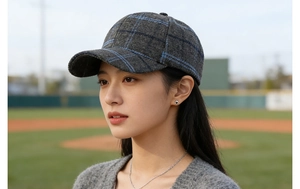 Detailed texture of grey and blue plaid wool baseball cap worn in outdoor sports setting