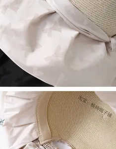 Detailed texture of woven straw sun hat with elegant bow jacquard fabric detail