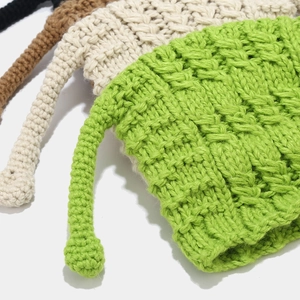 Close-up of thick chunky knit texture on colorful beanies with playful antennas