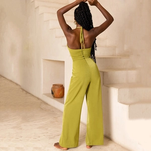Detail of light green halter neck jumpsuit showing the back tie design and wide legs