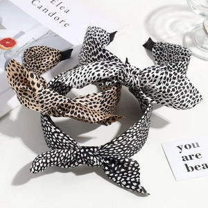 Three stylish leopard print bow headbands in silk fabric shown from a 45-degree angle