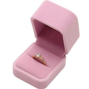 Elegant pink velvet jewelry box with rounded corners and gold ring display insert