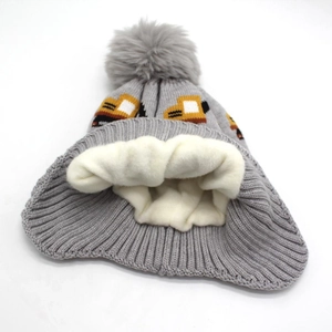 Detail view of the thick fleece lining and tractor jacquard on kids winter knit hat