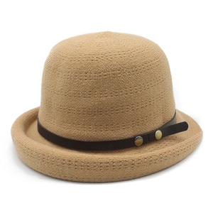 Detail view of khaki knit bucket hat with brown leather strap and metal rivets