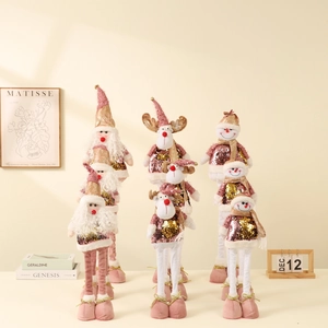 Pink and gold Christmas plush dolls featuring Santa, reindeer, and snowman figurines