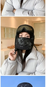 Detail of winter windproof trapper hat with camouflage pattern and integrated goggles