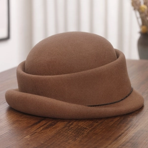 Detailed view of a brown wool felt beret with elegant black beaded chain trim