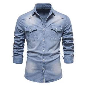 Detail of light blue denim shirt featuring a turn-down collar and chest pockets