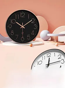Detail view of modern silent wall clocks in rose gold and black finish with large numerals