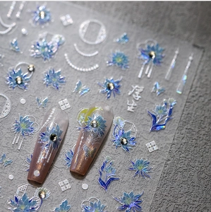 Close-up of 5D embossed nail stickers featuring aurora blue lotus and butterfly designs