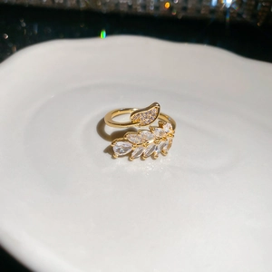 Detailed macro view of 18K gold-plated double leaf ring with sparkling zircon stones