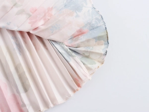 Detailed macro view of pleated floral fabric hem with pink and blue prints