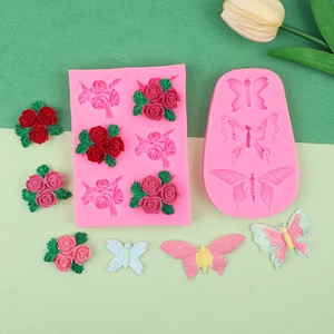 Macro detail of silicone molds showing intricate rose flower and butterfly textures