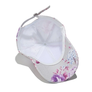 Detail of floral baseball cap showing white mesh lining and adjustable metal buckle strap