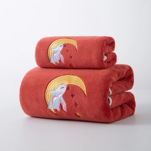Detailed view of soft coral fleece towels featuring cute embroidered rabbit on moon design