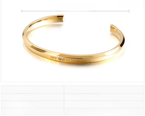 Detailed view of gold stainless steel bangle with MY LOVE engraving and zircon stone
