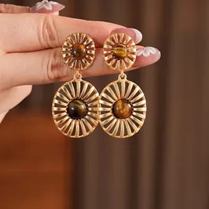 Vintage gold hollow sun-shaped earrings featuring natural oval tiger eye stone inlays