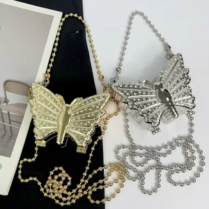 Elegant butterfly-shaped rhinestone clutch in gold and silver with metallic bead chains