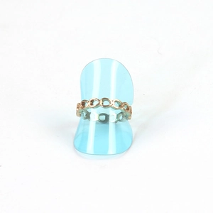 Golden hollow chain link ring displayed on a light blue transparent jewelry stand