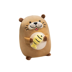 Cute brown plush otter holding a yellow fish accessory on a white background