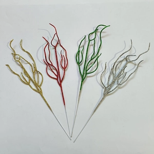 Glittery Christmas decorative branches in gold, red, green and silver for festive party decor